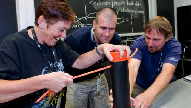 Three teachers working on an experiment together