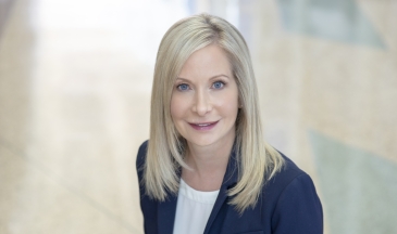 Aerial portrait of a woman with blonde hair wearing a navy suit