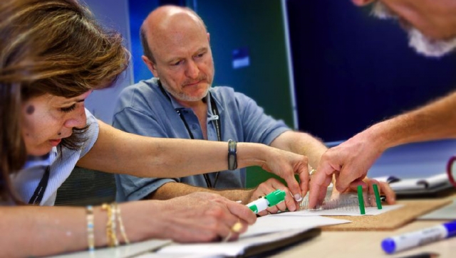 Three teachers working together on an experiment