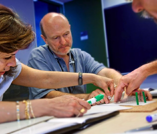 Three teachers working together on an experiment