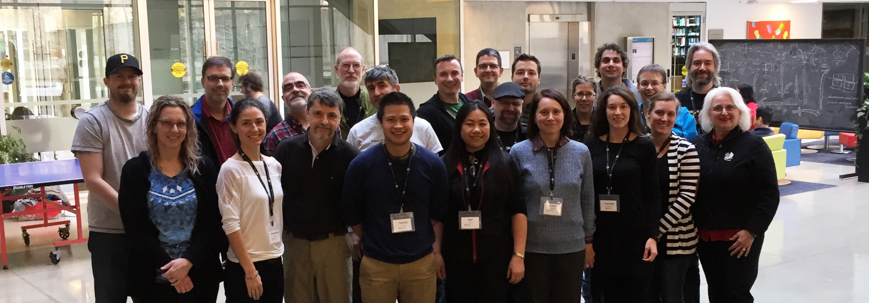 Group of teachers posing for a picture in an atrium