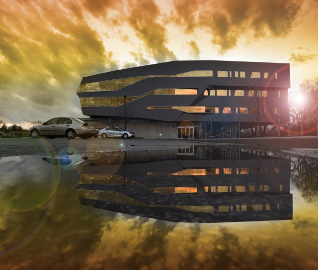 Perimeter Building facade yellow sky reflected in a puddle