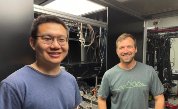 Two men standing in a computer lab together