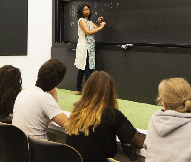 Woman teaching to a group of five students