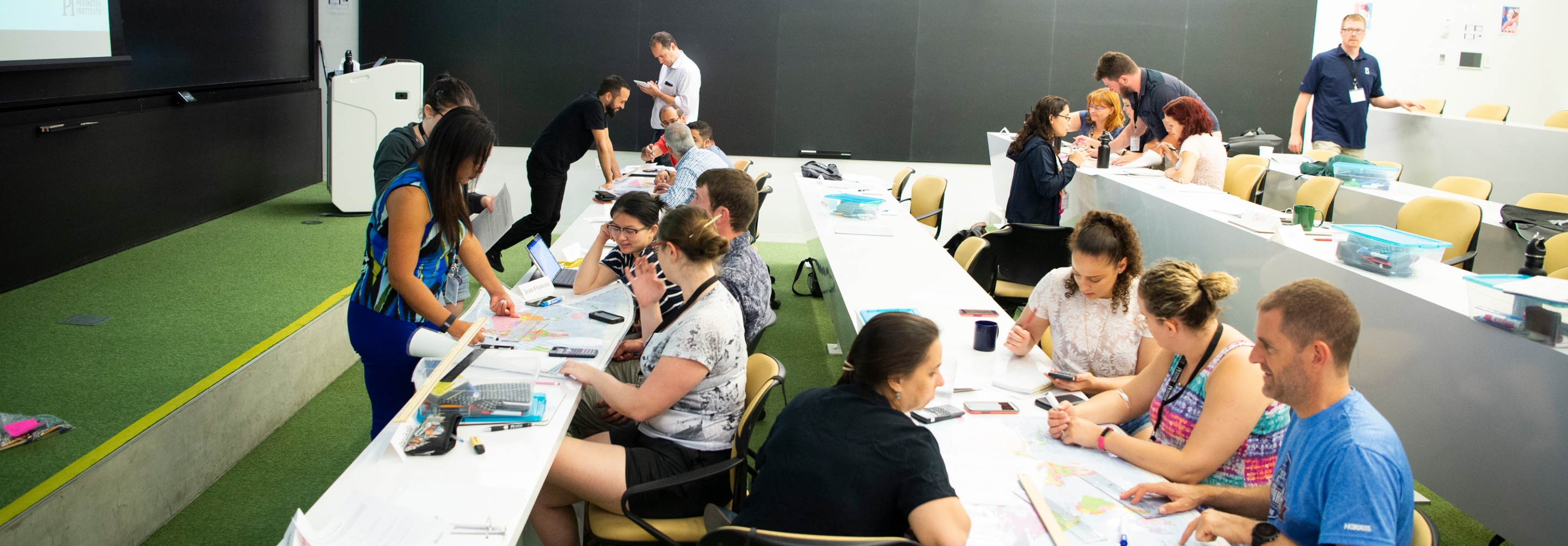 Groups of teachers doing activities together in a seminar room