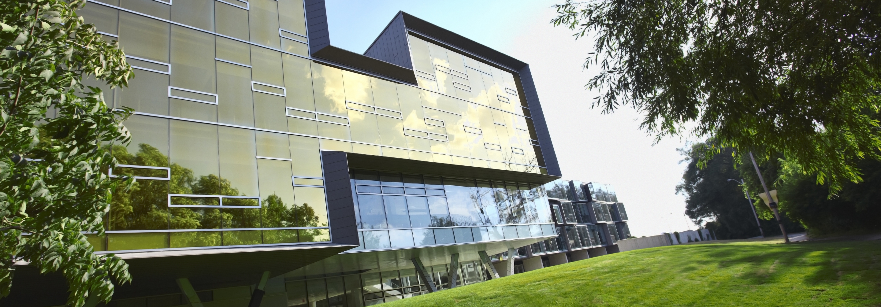 Exterior picture of building with gold glass wall