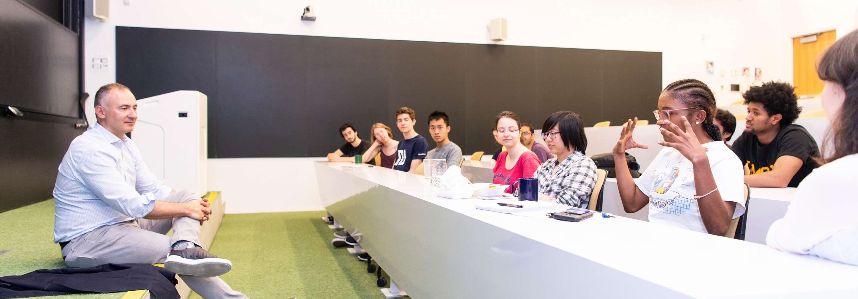 Man talking with a group of students